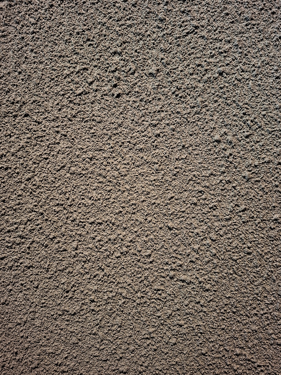 Tekstur permukaan Textura Sandspray dari dekat
